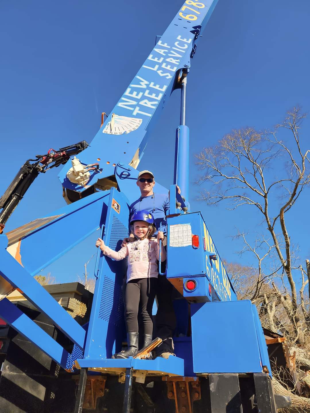 Owner Michael with his daughter standing on a crane